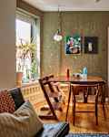 Stokke Tripp Trapp high chair tucked under dining table in light filled apartment.