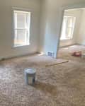 Paint bucket in middle of living room.
