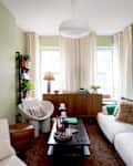 Paper pendant lantern hanging in neutral living room.