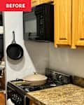 Kitchen corner with wooden cabinets, black microwave, and a beige pan on the stove, next to a sink and granite countertop.