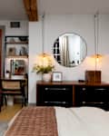 Wall lamps above bedroom dresser.