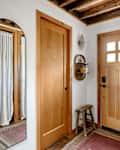 Wood doors in white entryway