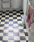 Old black and white tiled floor in kitchen