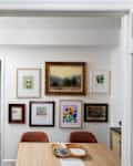 Framed art on white wall in dining room. Gallery wall.