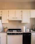 Rental kitchen with white cabinets and tan walls