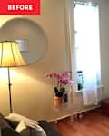 Cozy living room corner with a TV on a white media console, a lamp, and a pink orchid on a clear table.