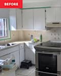 White kitchen with a stainless steel stove, beige countertops, and floral tile backsplash; items on the counter include a water bottle and cleaning cloth.