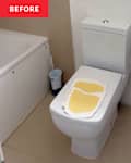 Toilet with yellow paper on top, small sink nearby, and a bathtub in the background.