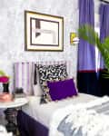 A bedroom with purple wallpaper, purple curtains, and a purple striped headboard