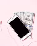 Mobile phone with headphones and money on pink background. Concept of payment and savings