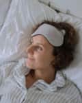 Woman smiling alone in bed