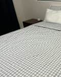Quince gingham duvet set on neatly made bed.