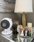 Woozoo 5-Speed Globe Fan on side table with lamp and other decor