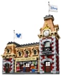 LEGO Disney Train Station set with Minnie, Chip, Dale, and Goofy figures, featuring a clock tower and Disney flags.