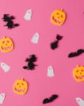 Halloween-themed cutouts of pumpkins, ghosts, cats, bats, and witches on a pink background.