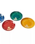 Four decorative plates in blue, green, red, and yellow, each with a unique emblem and stars.