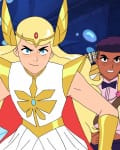 Three animated characters in a cave, led by a blonde warrior in gold armor, holding a glowing sword.