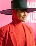 alicia keys on a red carpet wearing an all red outfit with a black wide brimmed hat