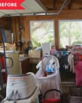 Cluttered garage with boxes, laundry basket, ladder, and various household items near large windows.