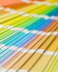 Fan of colorful paint swatches arranged in a gradient spectrum.