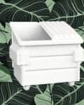 White toy dumpster on a green leaf-patterned background.