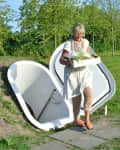 Woman carrying produce out of underground fridge