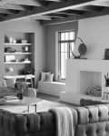 Modern living room with tufted sofas, large windows, built-in shelves, and a fireplace with decorative items.