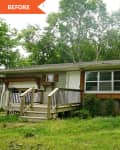 Single-story house with green siding, wooden shutters, front porch, and overgrown yard, surrounded by trees.