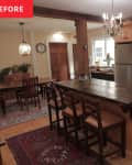 Rustic kitchen with wooden cabinets, island with stools, chandelier, and dining area with a large table and chairs.