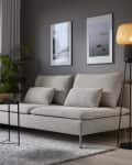 Beige sofa with cushions, floor lamp, two framed photos, and a potted plant in a modern living room.