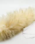 Feather duster with wooden handle next to a white cleaning cloth.