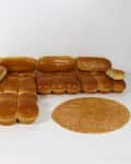 Bread rolls arranged to resemble a sectional sofa with a round mat in front.