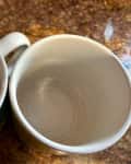Stained coffee mugs before cleaning.