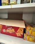 shelf in pantry with cracker boxes open