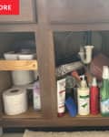 under sink cabinet with bottles and box scattered