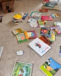 Children's books on floor during ODT decluttering method.