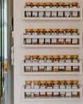 White matching spice racks hanging in kitchen