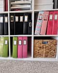 Binders organized in bookshelf.