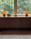 Matching lamps on credenza in living room.