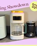 Coffee maker on kitchen counter surrounded by appliances.