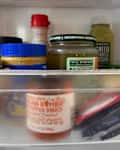 Condiments packets in refrigerator.