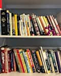 Books disorganized on bookshelf.