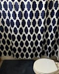 Blue and white curtain in bathroom before adding tea kettle tissue holder.