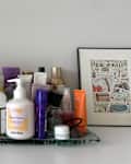 Toiletries on dresser before organizing.