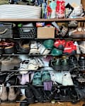 Shoes on messy entryway rack.