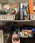 Cluttered shelf cart in bathroom before 10-10-100 challenge decluttering