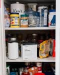 Pantry before organizing: shelves are full of goods with no real organization, looks somewhat messy