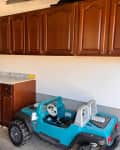 Old kitchen cabinets in garage being used for additional storage.