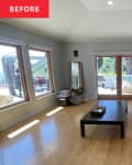 blue accent wall, wood floors, big picture windows, glass double doors, long rectangle room, low coffee table in center, arched ceiling, recess lighting, wardrobe in corner