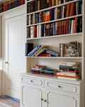 Books stored on built in bedroom shelves before remodel.